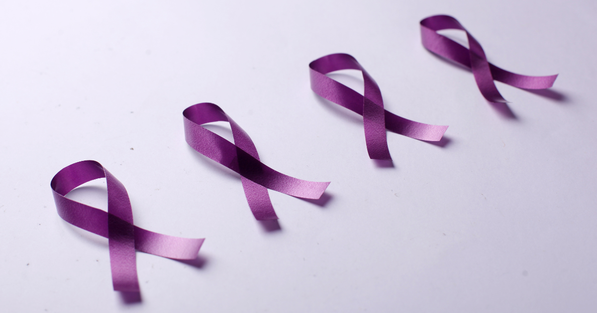 Four purple ribbons on a lavender-colored background, symbolizing International Overdose Awareness Day.